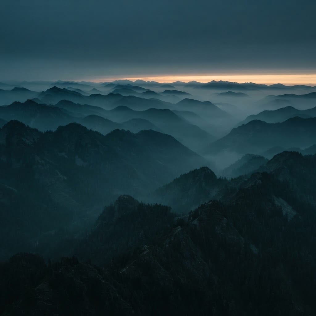 Layered misty mountain ridges at dawn, evoking a cross-border journey